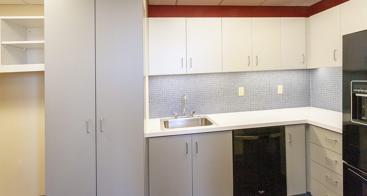 Kitchen with black appliances and white cabinets