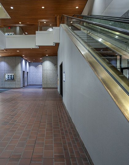Brick flooring with escalators going to the second floor from the lobby