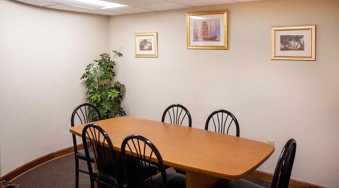 Conference room with a plant and pictures on the wall